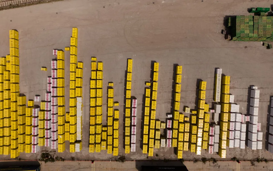 Overhead view of shipping containers arranged in a freight depot